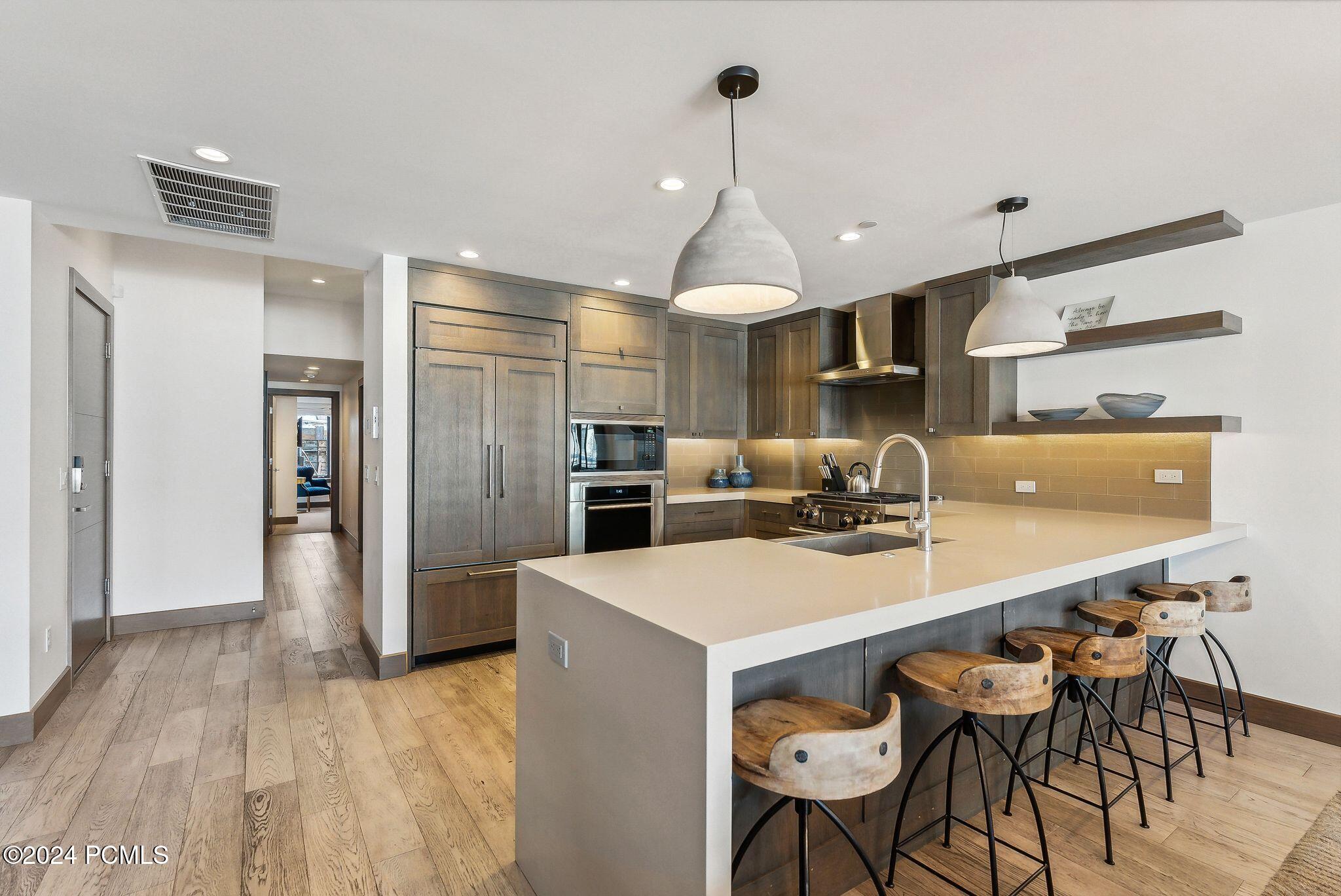 Kitchen island with bar seating and pendant lights