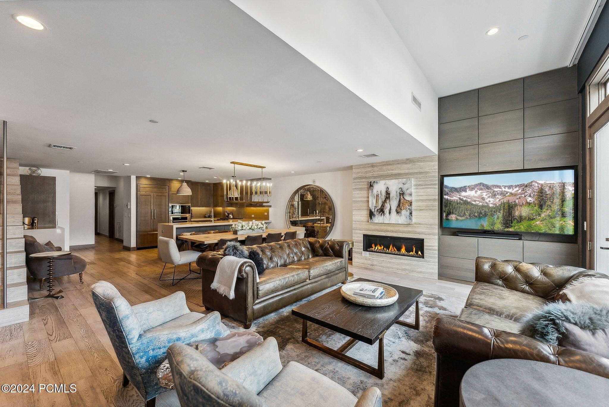 Open-concept living room with fireplace at Summit on Main Park City penthouse