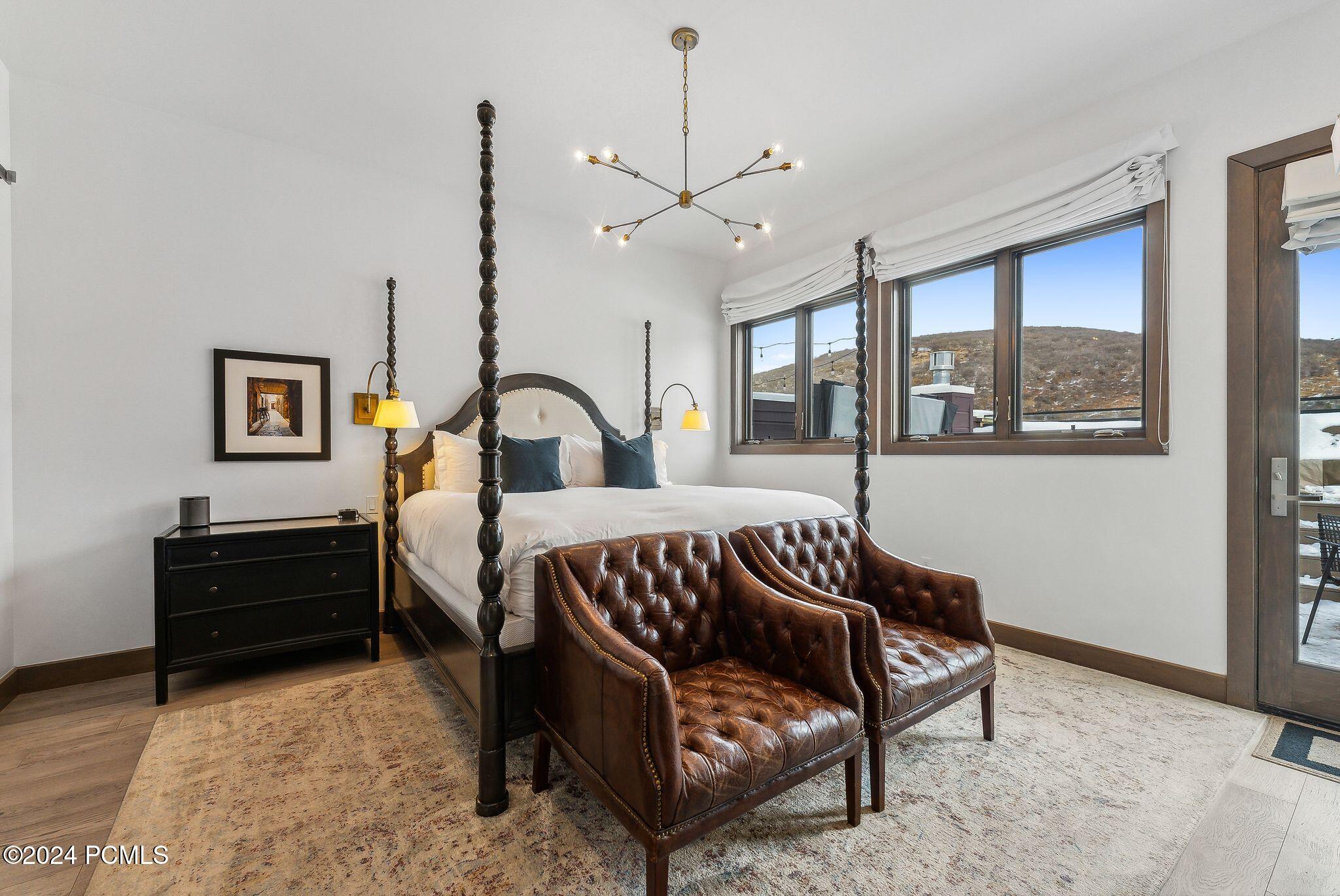 Primary suite king bed with rooftop access door