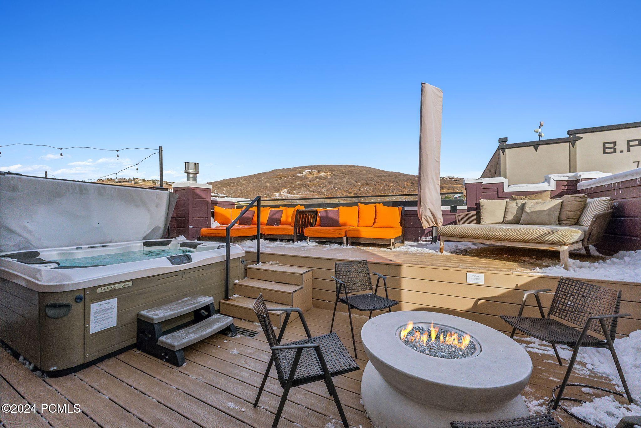 Rooftop hot tub and fire pit with mountain views in Park City summer