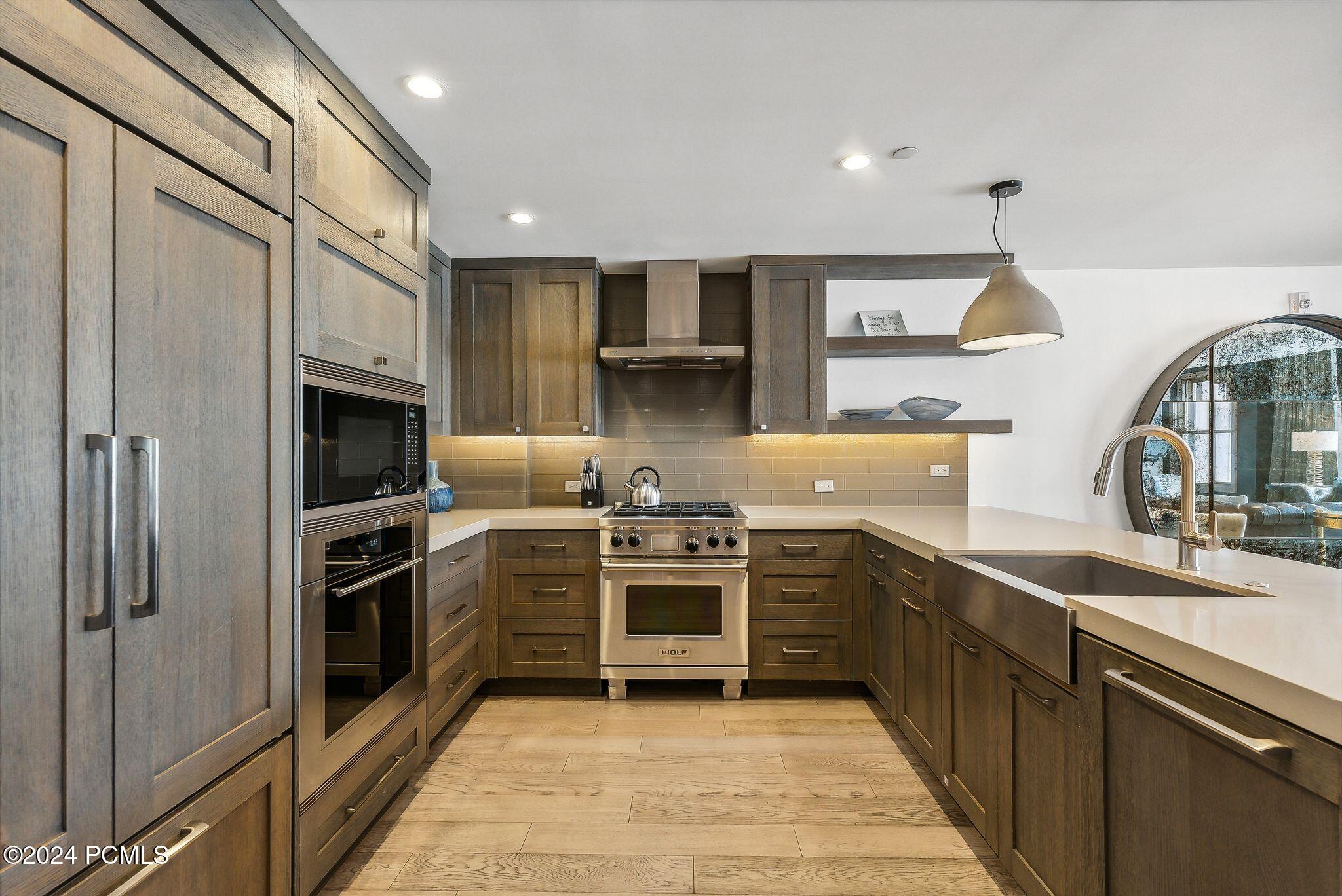 Wolf appliances and custom dark wood cabinetry