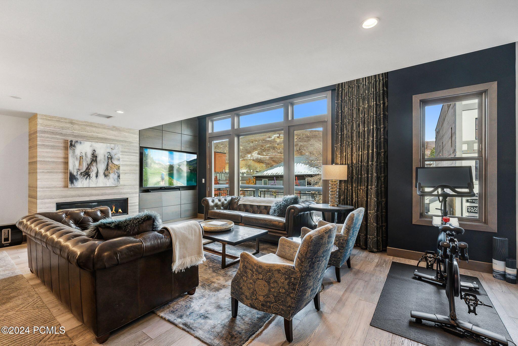 Summit on Main living room with fireplace and mountain views — luxury family vacation rental Park City