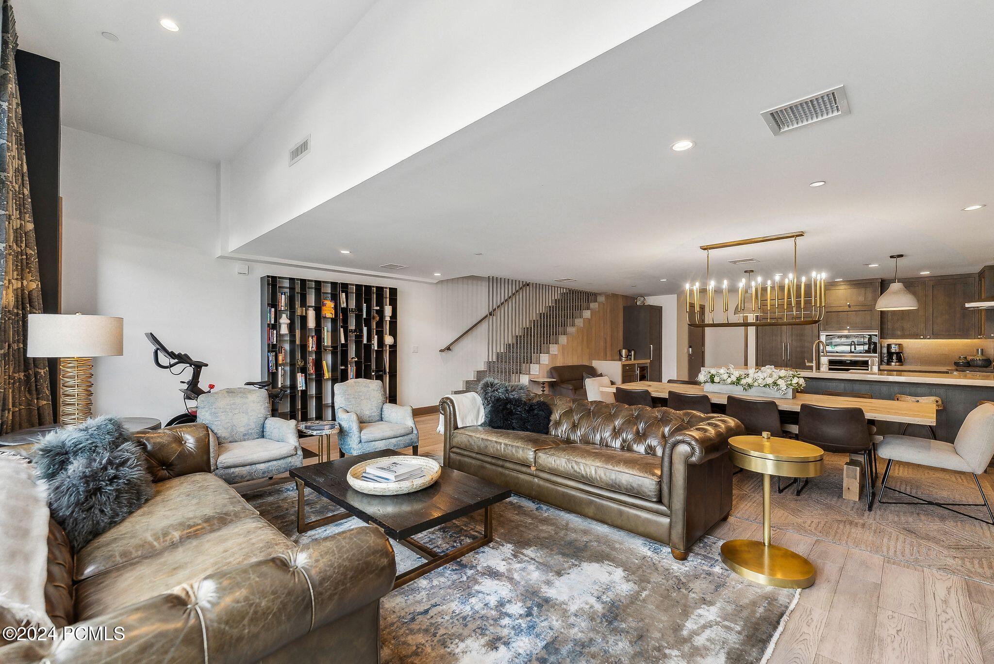 Living room with modern staircase and bookshelf