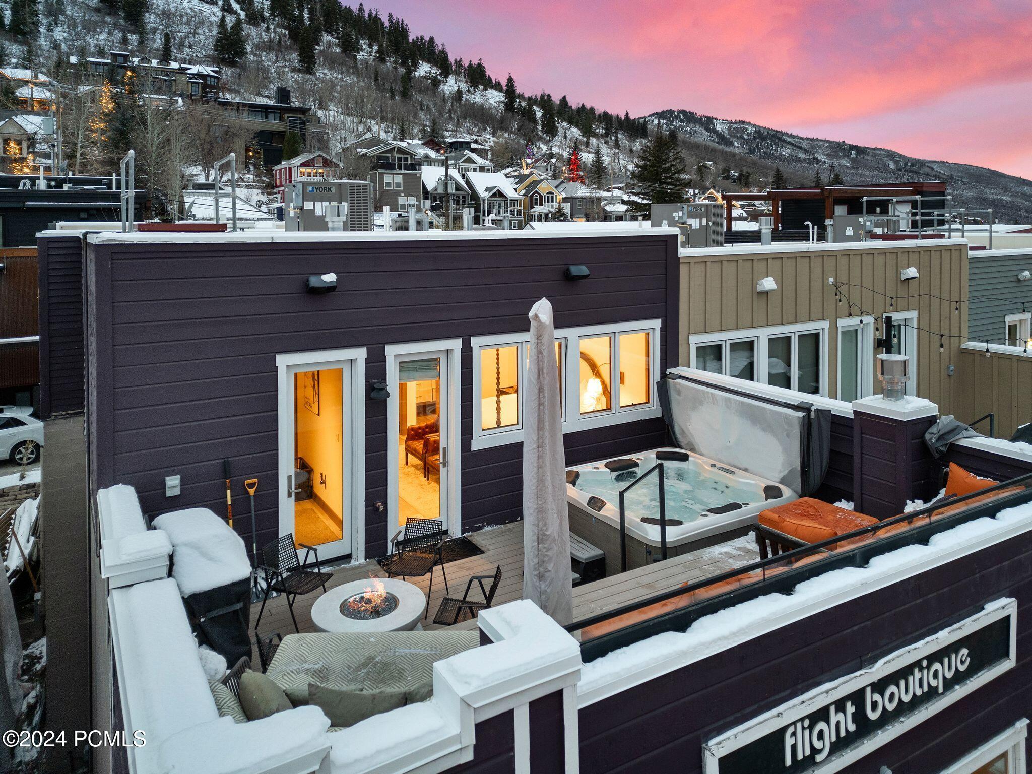Aerial view of rooftop with hot tub and fire pit